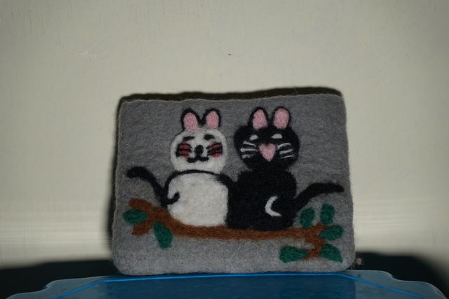Embroidered felt coaster with two cats on a branch