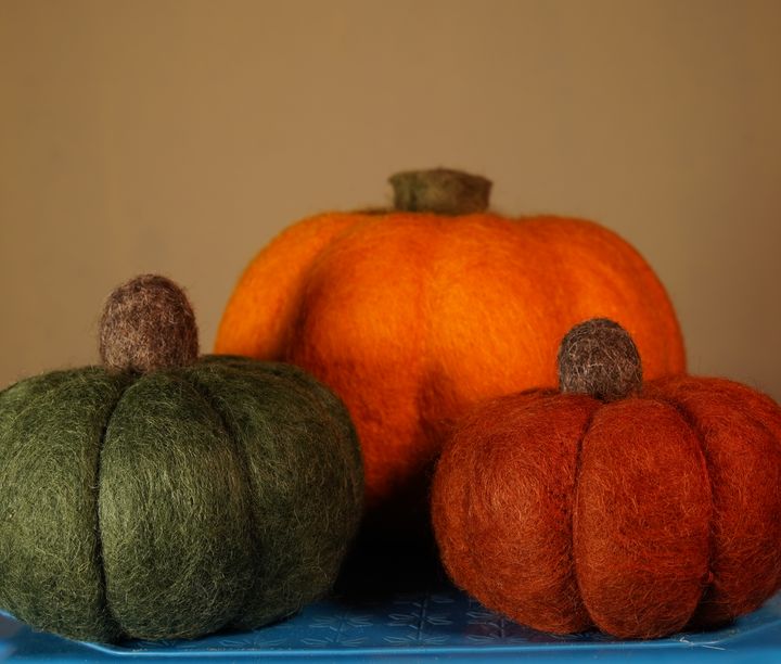Handmade felt pumpkins in orange and green