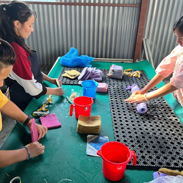 Artisans working together on felt pieces