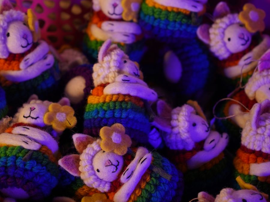 A colorful heap of handmade felt sheep toys